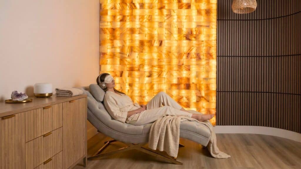 Woman relaxing in salt room lounge chair at Goji Yoga & Wellness in Oakville